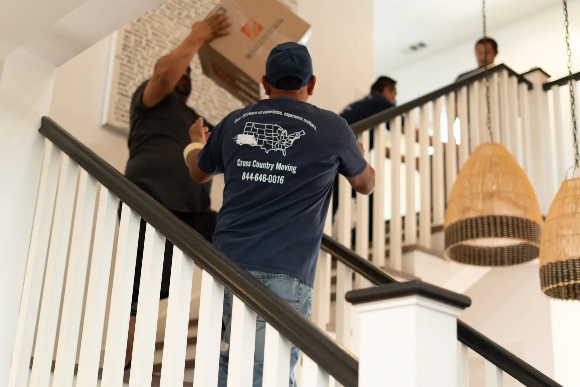 Cross Country Moving team carrying items downstairs for Dallas move